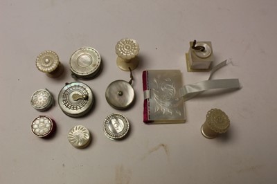 Lot 2598 - Twelve mostly Victorian mother of pearl sewing accessories, including tape measures, waters, pin cushions