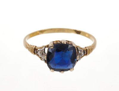 Lot 583 - Sapphire and diamond ring with a cushion cut blue sapphire