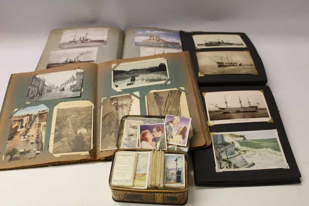 Lot 1348 - Postcards selection in home made albums including home made albums including topographical, good range of shipping cards plus some cigarette cards.