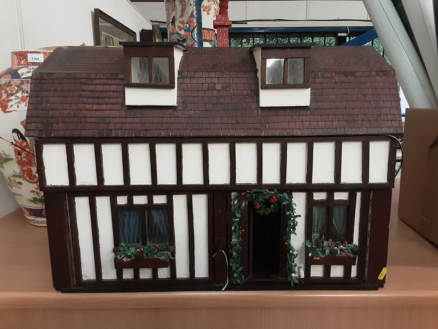 Lot 2 - Good quality dolls house by G Ponnock. with electric light fitting and fitted with furniture