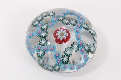 Lot 302 - Baccarat glass paperweight - a trefoil blue double garland on a clear ground with a central millefiori cane, 55mm diameter