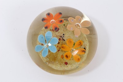 Lot 304 - Glass paperweight by Frank Eisner, with four lamp work flowers arising from a mound, 75mm diameter