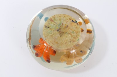 Lot 304 - Glass paperweight by Frank Eisner, with four lamp work flowers arising from a mound, 75mm diameter