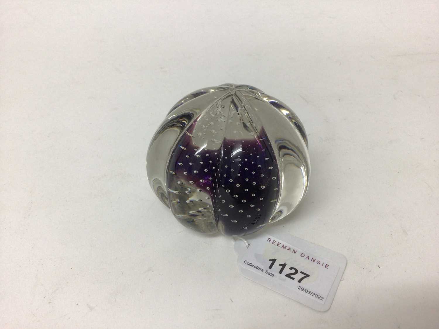 Lot 1127 - A clear glass paperweight of lobed form, encasing a central purple cushion feature surrounded by minute bubbles, probably Scottish, 80mm diameter