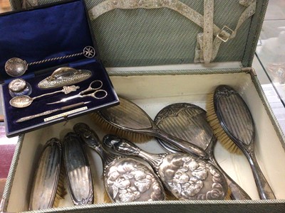 Lot 653 - Silver backed dressing table items, manicure set in fitted case and two spoons, all within vintage suitcase