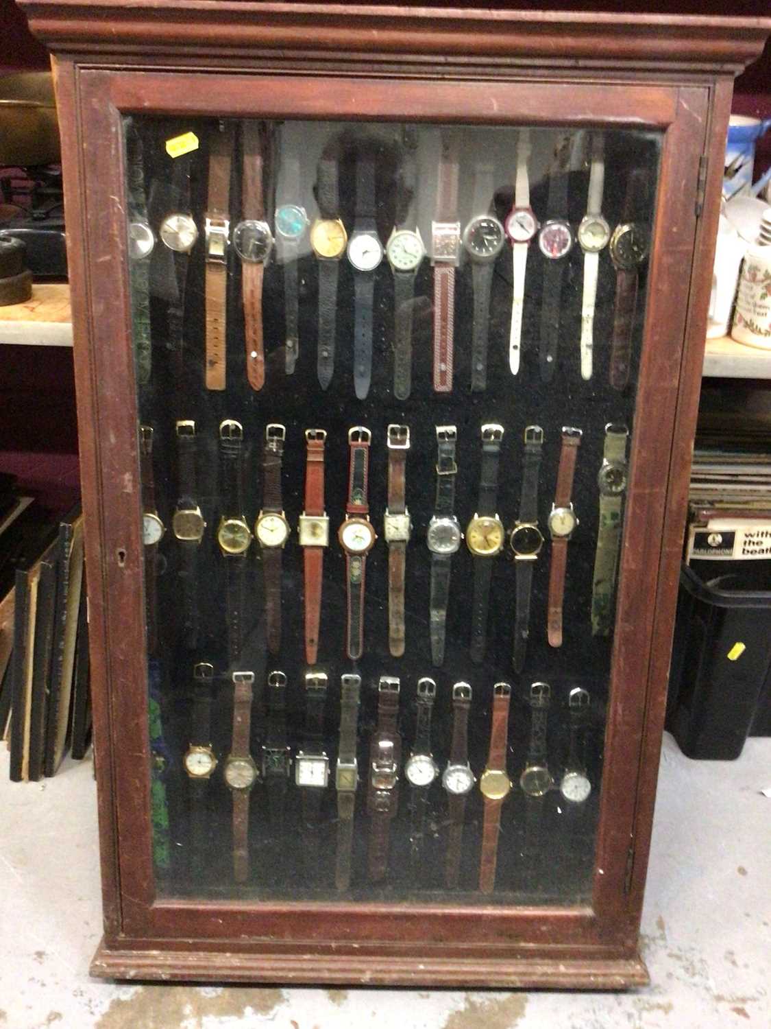 Lot 539 - Glazed display cabinet full of wristwatches