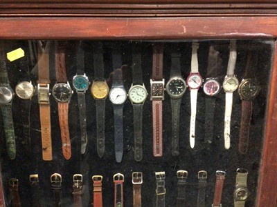 Lot 539 - Glazed display cabinet full of wristwatches