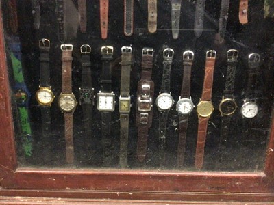 Lot 539 - Glazed display cabinet full of wristwatches