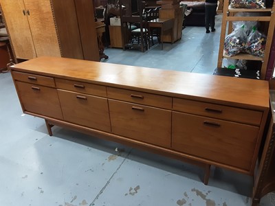 Lot 853 - Mid 20th century White & Newton Ltd long teak sideboard with four drawers and cupboards below enclosing drawer and drinks compartment, 233cm wide, 46cm deep, 78cm high