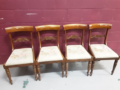 Lot 855 - Set of four Regency mahogany dining chairs with carved bar backs and drop in floral tapestry seats on turned front legs