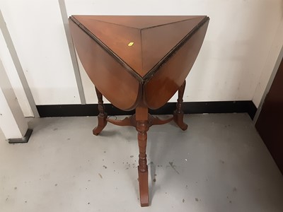 Lot 859 - Late Victorian walnut drop flap table of triangular form with ring turned supports joined by stretchers