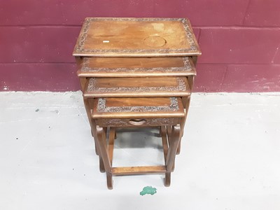 Lot 860 - Oriental nest of four occasional tables with carved decoration