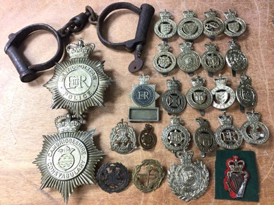 Lot 408 - Box of police related memorabilia, including badges and an old pair of iron handcuffs