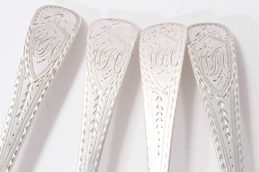 Lot 370 Set of four bright cut silver table spoons