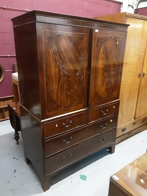 Lot 869 - Georgian inlaid mahogany linen press with two doors above enclosing slides, two short and two long graduated drawers below on bracket feet, 122cm wide, 61.5cm deep, 184cm high