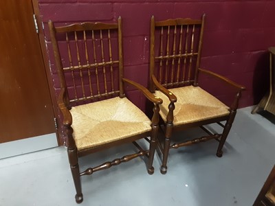 Lot 870 - Set of six oak spindle back chairs with rush seats comprising four standards and two carvers