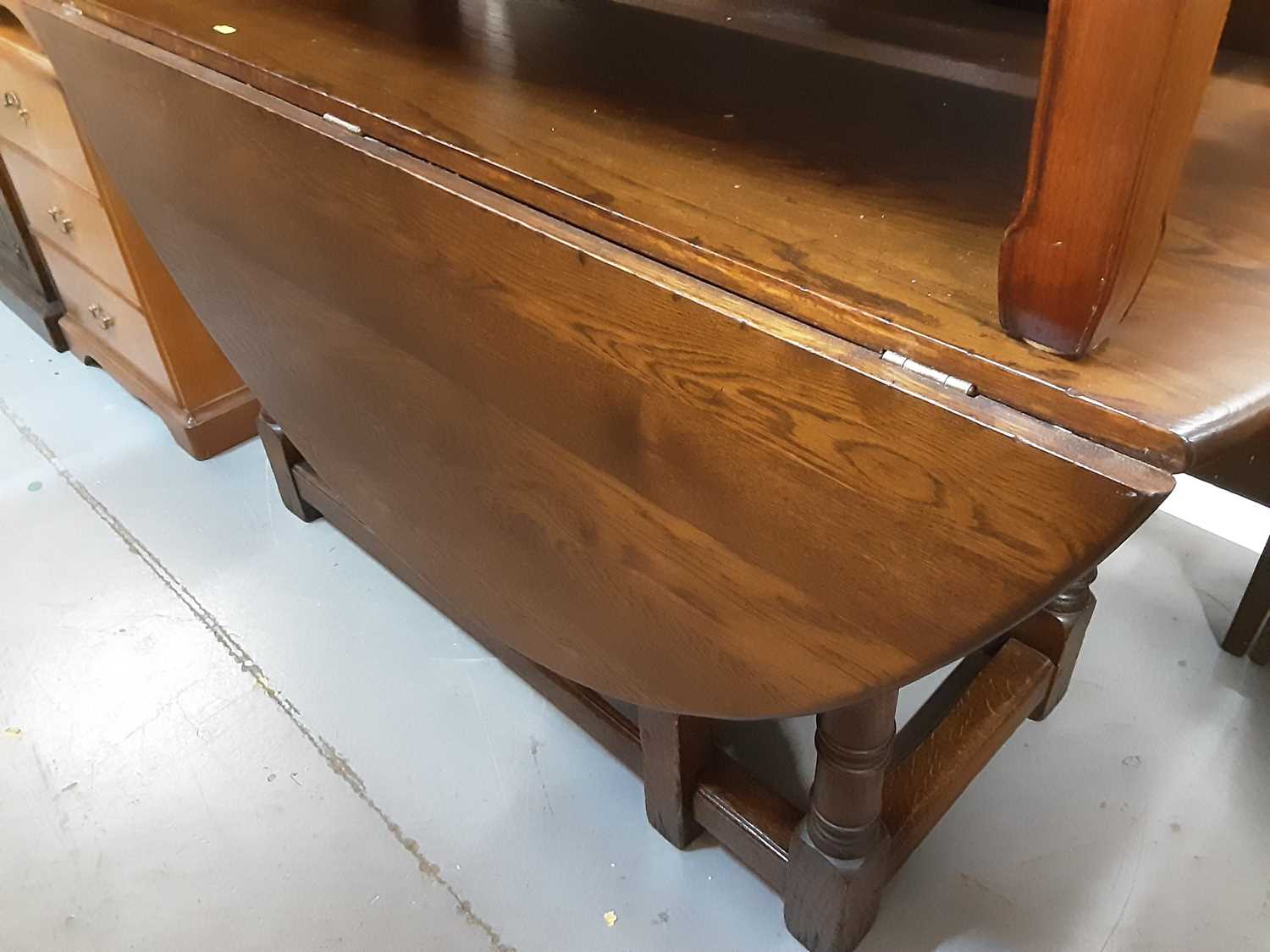 Lot 881 - Large oak oval drop leaf dining table on turned and block legs, opening to 166cm x 145cm