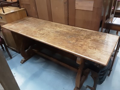 Lot 910 - Oak refectory table on shaped end standards joined by stretcher, 183cm wide, 61cm deep, 76cm high